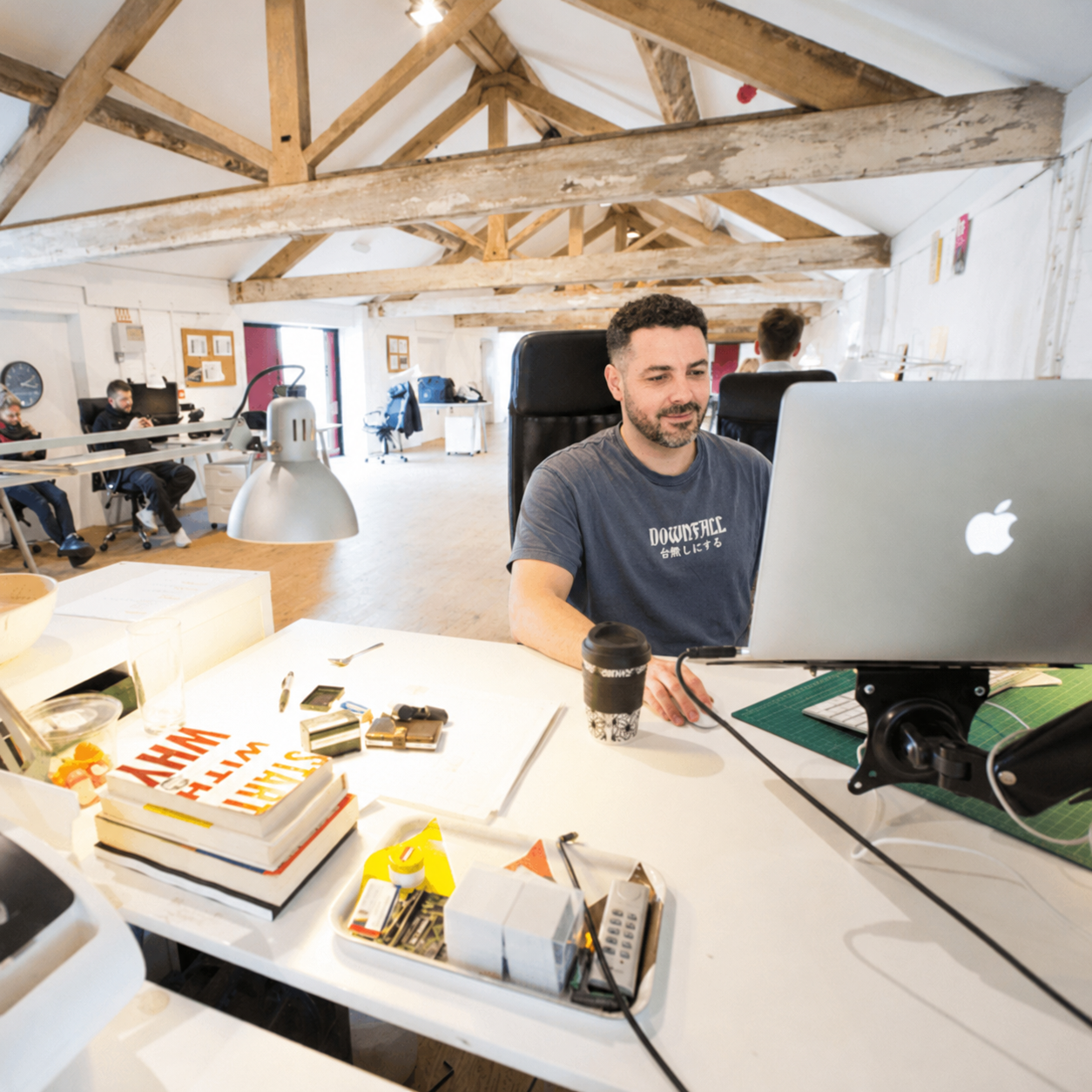 Pablo Mazzini working at a large desktop monitor in a creative studio